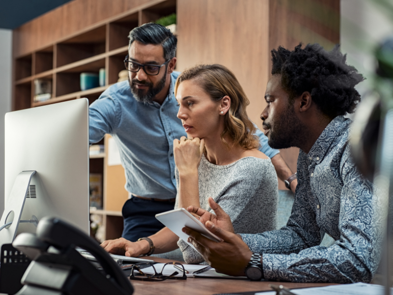 A team of IT professionals working together on solving tech issues