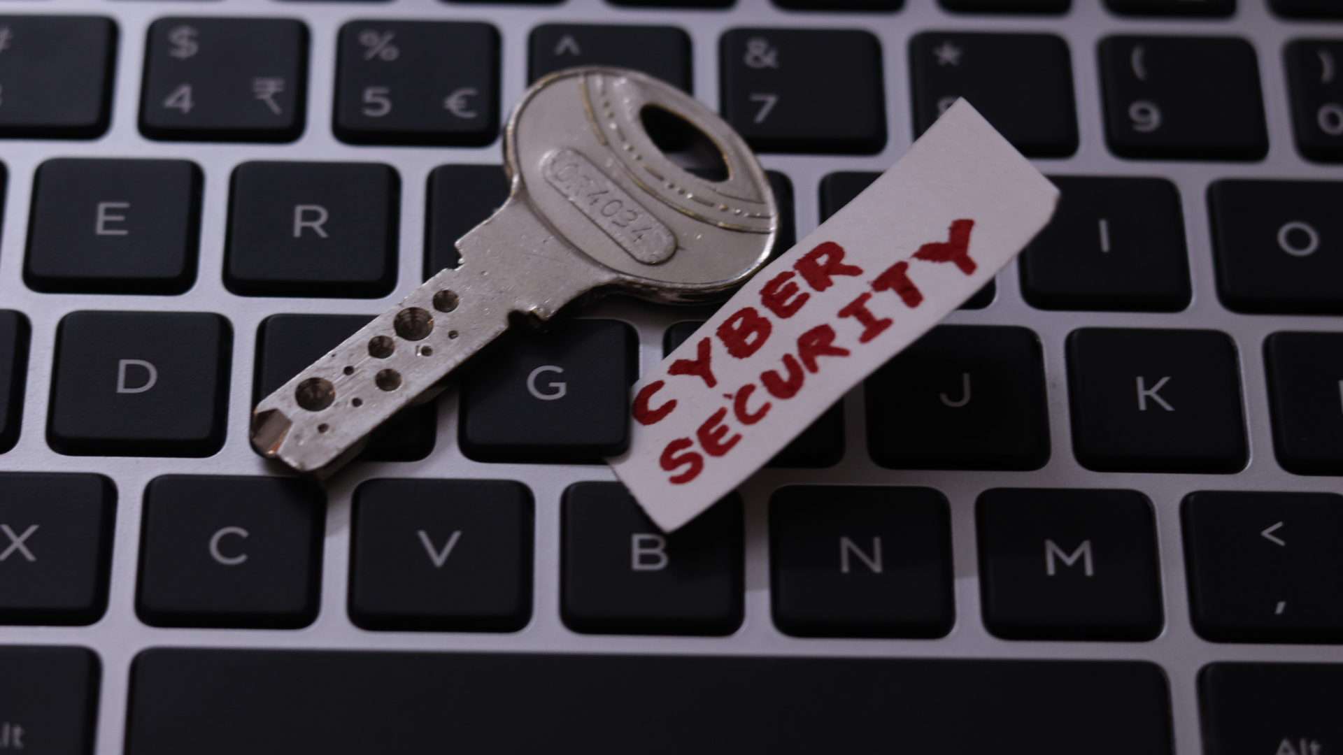 main blog image showing a key and tag labelled cyber security sitting on a keyboard