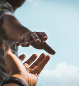 two hands approaching to help