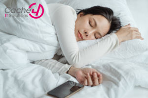 Woman sleeping in bed near smartphone