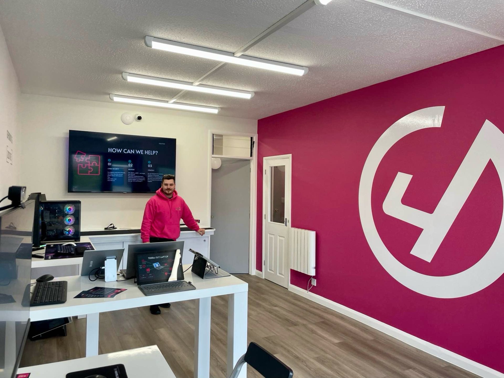 employee standing in computer shop where February Love Campaigns will be located